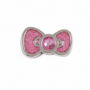 Pink glittery bow charm with a central gem on a white background