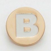 Gold circular object with letter 'B' on a white background