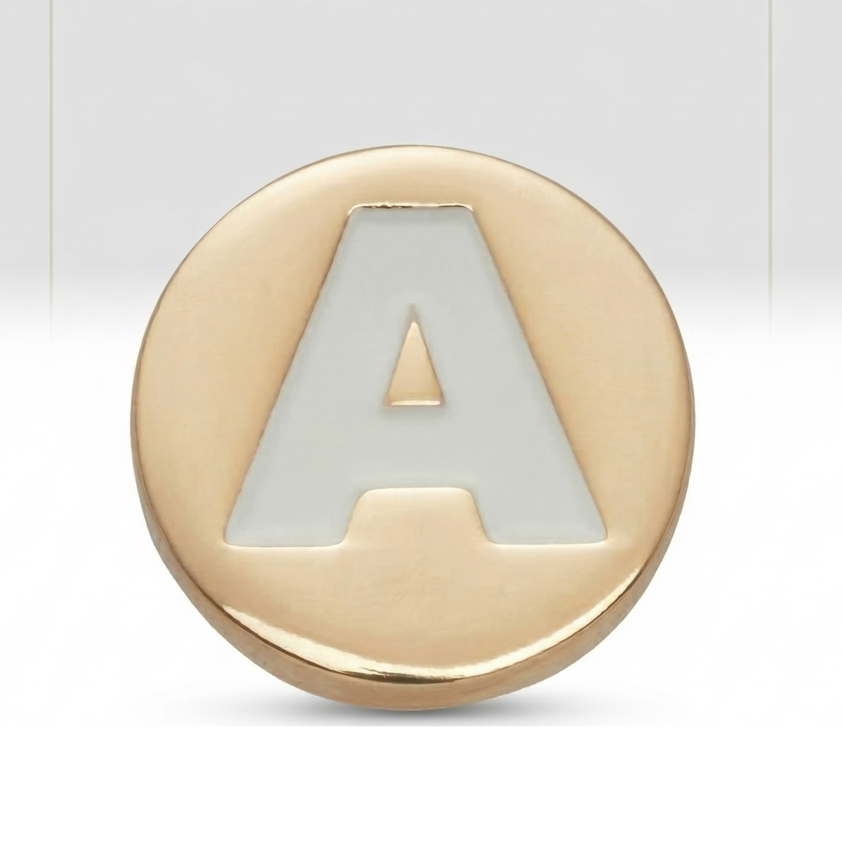 Gold charm with letter 'A' on a white background